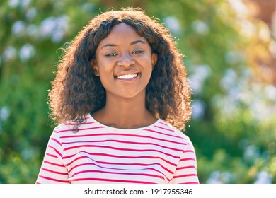 Young african american girl smiling happy standing at the park.