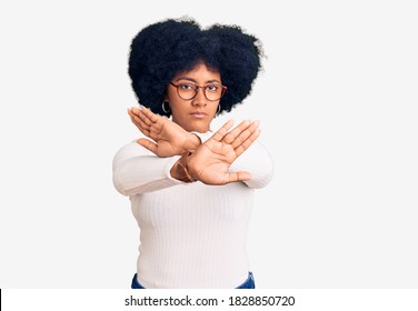 Young african american girl wearing casual clothes and glasses rejection expression crossing arms doing negative sign, angry face  - Shutterstock ID 1828850720