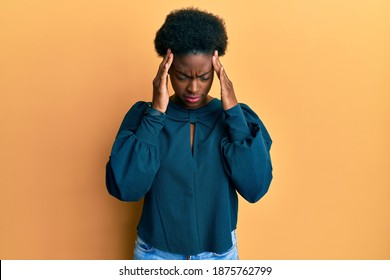 Young african american girl wearing casual clothes with hand on head for pain in head because stress. suffering migraine.  - Shutterstock ID 1875762799