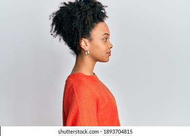 Young african american girl wearing casual clothes looking to side, relax profile pose with natural face and confident smile. 