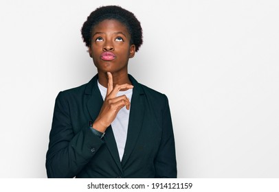 Young African American Girl Wearing Business Clothes Thinking Concentrated About Doubt With Finger On Chin And Looking Up Wondering 