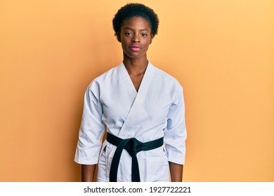 Young african american girl wearing karate kimono and black belt relaxed with serious expression on face. simple and natural looking at the camera.  - Powered by Shutterstock