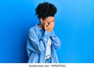 Young african american girl wearing casual clothes with sad expression covering face with hands while crying. depression concept.  - Shutterstock ID 1999297622