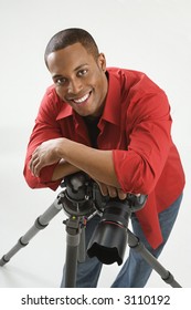 Young African American Male Adult Photographer Posing In Studio.