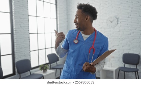 Young african american man in blue scrubs with a stethoscope pointing to the side in a hospital waiting room. - Powered by Shutterstock