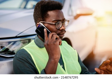 Young African American Man Calling Towing Service For Help On The Road. Roadside Assistance Concept.