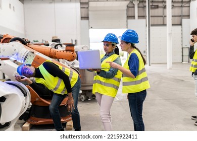 Young African American Man Checking The Machine While Two Women Looking At Laptop And Checking The Data