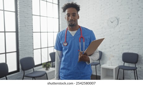 Young african american man doctor in a hospital waiting room holding a clipboard. - Powered by Shutterstock