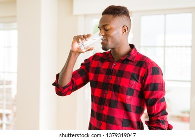 Young african american man drinking a fresh glass of water