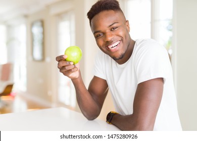 Young African American Man Eating A Healthy Green Apple