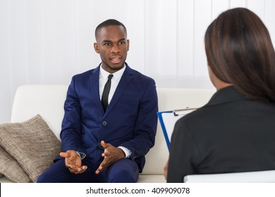 Young African American Man Explaining His Problems To The Psychologist