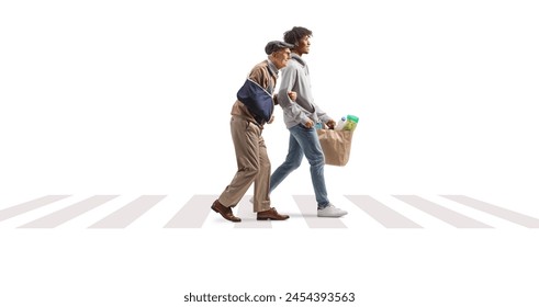Young african american man helping a senior with an injury and carrying grocery bags at a pedestrian crossing isolated on white background - Powered by Shutterstock