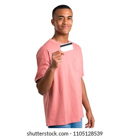 Young African American Man Holding A Credit Card On Isolated White Background