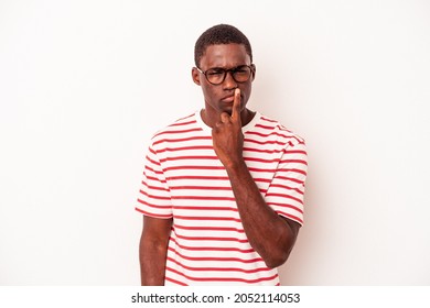Young African American man isolated on white background thinking and looking up, being reflective, contemplating, having a fantasy.