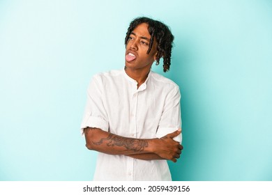 Young African American Man Isolated On Blue Background Funny And Friendly Sticking Out Tongue.