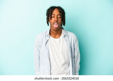 Young African American Man Isolated On Blue Background Funny And Friendly Sticking Out Tongue.