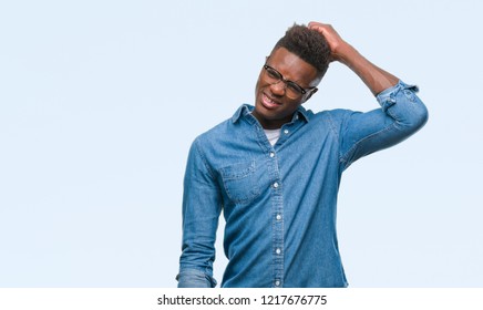 Young african american man over isolated background confuse and wonder about question. Uncertain with doubt, thinking with hand on head. Pensive concept.
