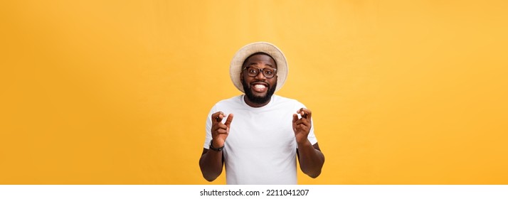 Young African American Man Over Isolated Background Smiling Crossing Fingers With Hope And Eyes Closed. Luck And Superstitious Concept