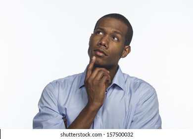 Young African American man thinking and looking up, horizontal