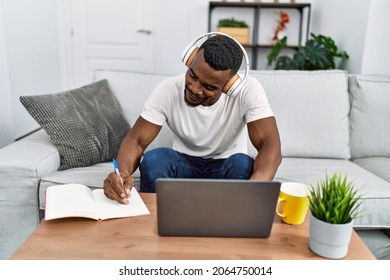 Young African American Man Using Laptop Studing At Home