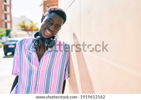 Similar – Young black man listening to music