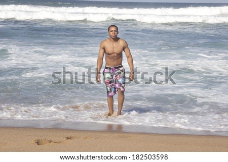 Young African American man walking on the beach