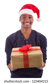 Young African American Man Wearing A Santa Hat Offering A  Gift , Isolated On White Background