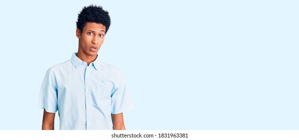 Young African American Man Wearing Casual Clothes In Shock Face, Looking Skeptical And Sarcastic, Surprised With Open Mouth 