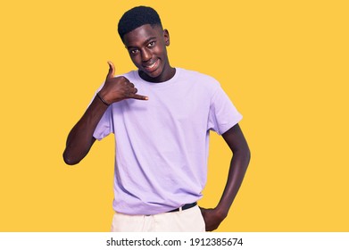 Young African American Man Wearing Casual Clothes Smiling Doing Phone Gesture With Hand And Fingers Like Talking On The Telephone. Communicating Concepts. 