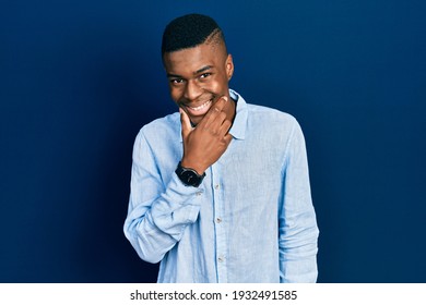 Young African American Man Wearing Casual Clothes Looking Confident At The Camera Smiling With Crossed Arms And Hand Raised On Chin. Thinking Positive. 