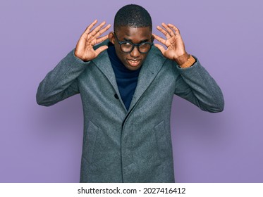 Young African American Man Wearing Business Clothes And Glasses Trying To Hear Both Hands On Ear Gesture, Curious For Gossip. Hearing Problem, Deaf 