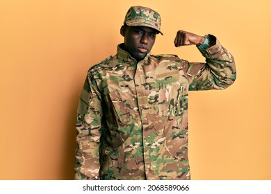 Young african american man wearing army uniform strong person showing arm muscle, confident and proud of power  - Powered by Shutterstock