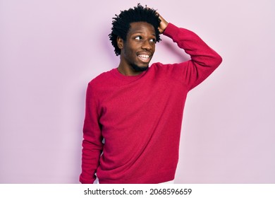 Young african american man wearing casual clothes smiling confident touching hair with hand up gesture, posing attractive and fashionable  - Shutterstock ID 2068596659
