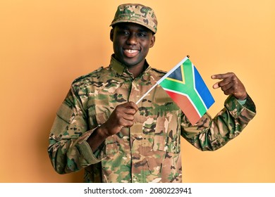 Young African American Man Wearing Army Uniform Holding South Africa Flag Smiling Happy Pointing With Hand And Finger 