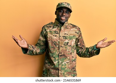 Young african american man wearing army uniform smiling showing both hands open palms, presenting and advertising comparison and balance  - Powered by Shutterstock