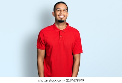 Young african american man wearing casual polo with a happy and cool smile on face. lucky person.  - Powered by Shutterstock