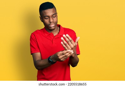 Young African American Man Wearing Casual Red T Shirt Suffering Pain On Hands And Fingers, Arthritis Inflammation 