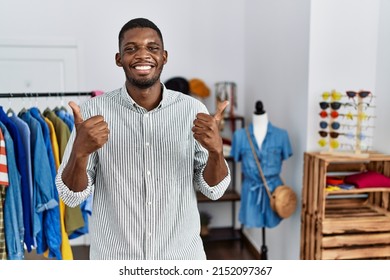 Young African American Man Working As Manager At Retail Boutique Success Sign Doing Positive Gesture With Hand, Thumbs Up Smiling And Happy. Cheerful Expression And Winner Gesture. 