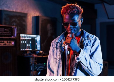 Young african american performer rehearsing in a recording studio.