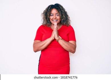 Young African American Plus Size Woman Wearing Casual Clothes Praying With Hands Together Asking For Forgiveness Smiling Confident. 