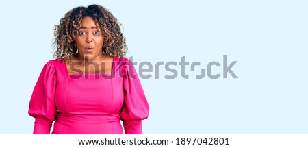Young african american plus size woman wearing casual clothes scared and amazed with open mouth for surprise, disbelief face 