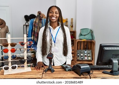 Young African American Shopkeeper Woman Smiling Happy Standing By The Counter At Clothing Store.