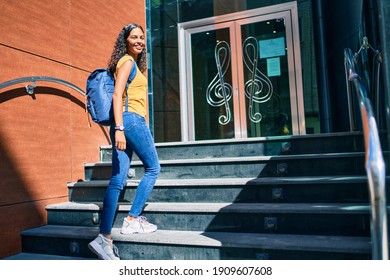 Young African American Student Girl Smiling Happy Going Up Stairs Of Music Academy.