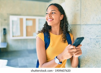 Young African American Student Girl Using Smartphone At University.