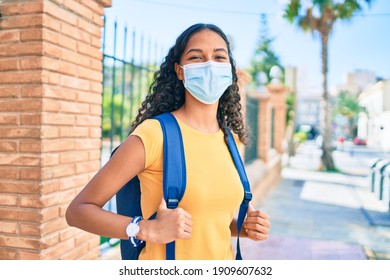 Young African American Student Girl Wearing Medical Mask Walking At University Campus.