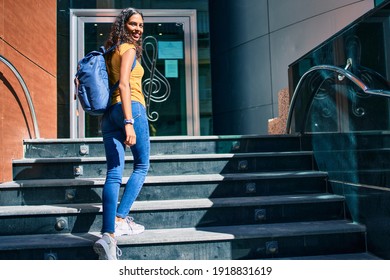 Young African American Student Girl Smiling Happy Going Up Stairs Of Music Academy.