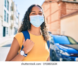 Young African American Student Girl Wearing Medical Mask Walking At University Campus.