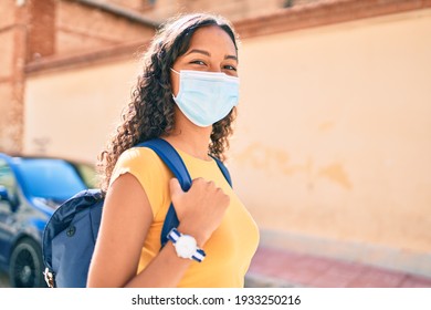 Young African American Student Girl Wearing Medical Mask Walking At University Campus.