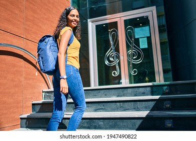 Young African American Student Girl Smiling Happy Going Up Stairs Of Music Academy.