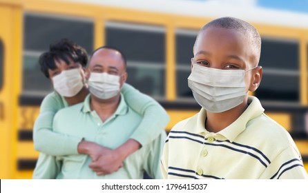 Young African American Student and Parents Near School Bus Wearing Medical Face Masks During Coronavirus Pandemic. - Powered by Shutterstock